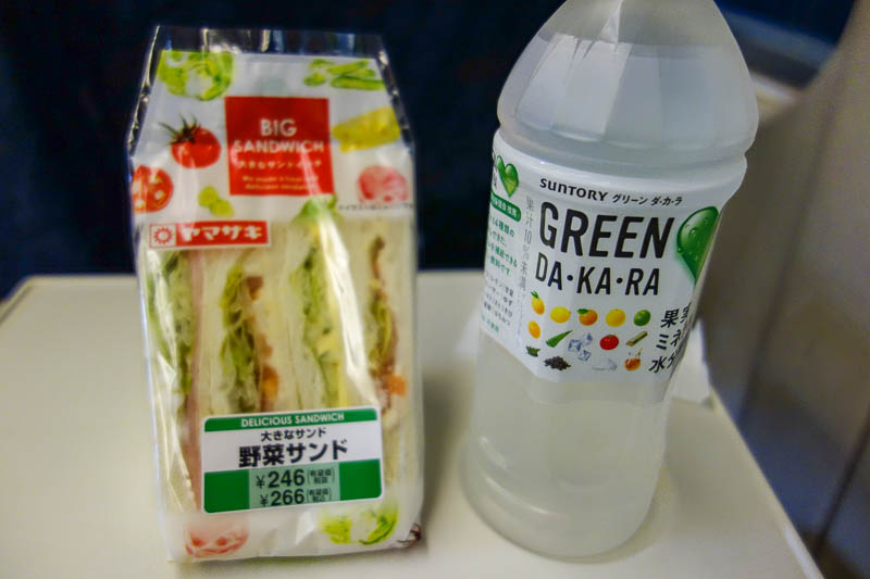 Japan-Hiroshima-Shimonoseki-Shinkansen - Time to enjoy my sandwich and lemon water. I have developed a real taste for white bread sandwiches with the crusts cut off. Mainly because of how che