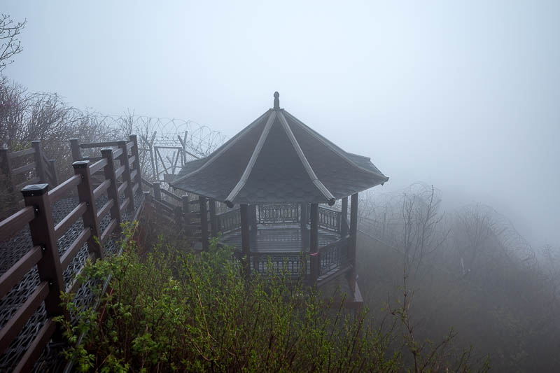 Korea-Seoul-Hiking-Yongmunsan - There are a lot of barbed wire fences, but they still managed to stick a pagoda up here. It was very windy on the summit so I did not want to hang aro