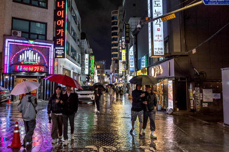 Korea-Seoul-Myeongdong-Food - Everyone but me with an umbrella.