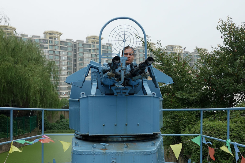 Back to China - Shanghai - Nanjing - Hangzhou - 2012 - Despite being an aerospace park, they have a torpedo boat floating in an algae filled swamp. I climbed aboard to fire the gun. People thought I was qu
