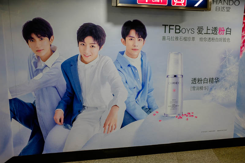 China-Beijing-Xidan-Food - It's the famous TFBoys, what are they selling? Face whitening cream. Everybody wants to be white.