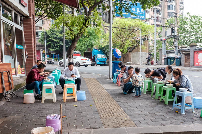 The great loop of China - April 2018 - Here we have a scene repeated at thousands of places across the city, typical Chongqing breakfast. You go to a noodle cart, they add various pastes an