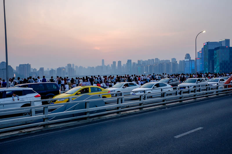 The great loop of China - April 2018 - Time to head out over the bridge. Here are the throngs of people heading back after capturing the great sunset, the sun was bright red, I missed it be