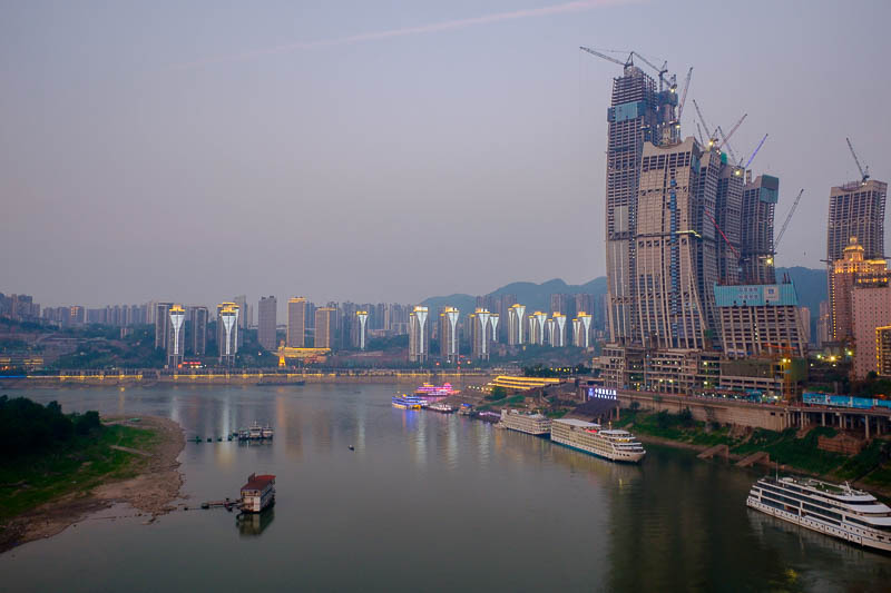 The great loop of China - April 2018 - Some of the cruise ships are firing up their neon lights ready for the dinner cruises. We will see one again a bit later.