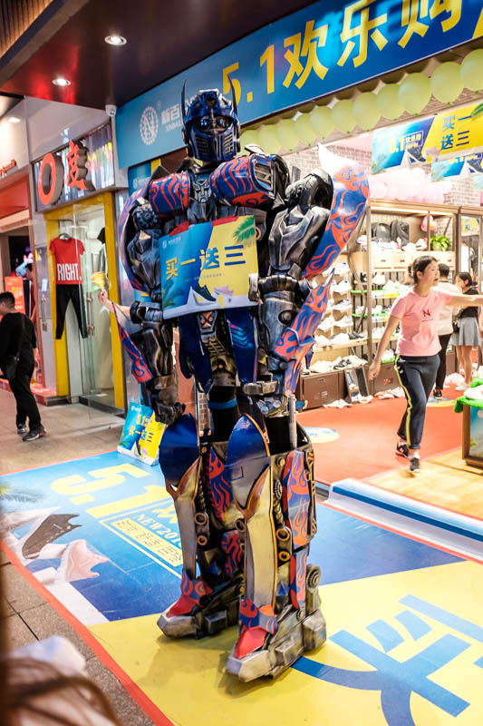 China-Wuhan-Pedestrian Street-Mall - As well as clowns on stilts, there were probably 5 giant transformers advertising out the front of stores. China loves giant robots.