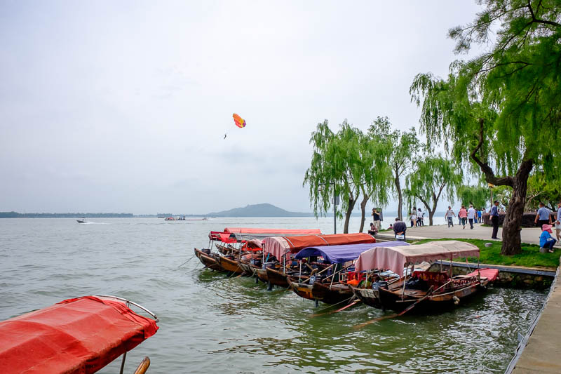 China-Wuhan-East Lake-View - A brave para-sailer trusting a Chinese parachute. Also if you go for a ride on one of those junks they make you put on a life jacket. I found that int