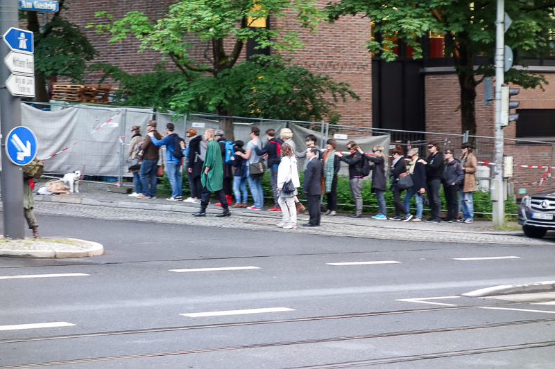 London / Germany / Austria - Work & Holiday - May and June 2016 - This is a group of young people, blindfolded, standing near a homeless person and his dog, forming a kind of joined conga line whilst roaming around t