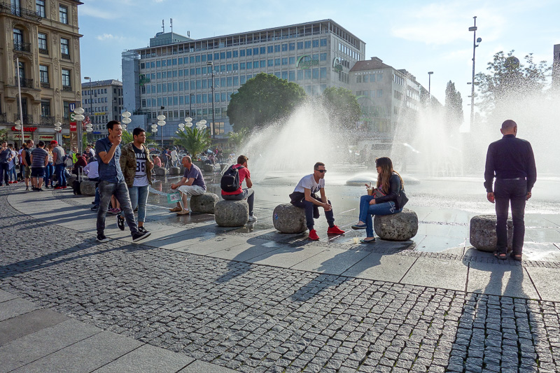 Germany-Munich-Shopping Street - Blazing sunshine had people jostling for position around the fountain.