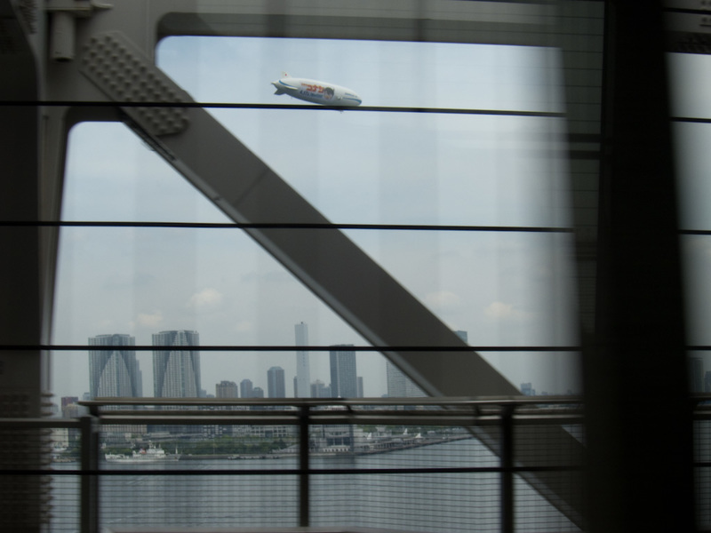 Japan-Tokyo-Odaiba-Shibuya - Im rinding on a monorail, going over the rainbow bridge, and watching a blimp fly past. Yes I was quite excited.