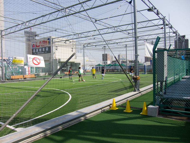 Japan-Tokyo-Ginza-Ikebukuro - On the roof of a 12 storey electronics shop (top 2 floors were restaurants), is 5 a side soccer. I had no idea, I just kept going up the stairs and en