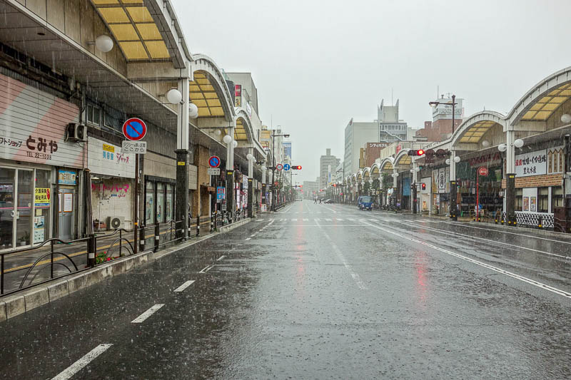 Japan 2015 - Tokyo - Nagoya - Hiroshima - Shimonoseki - Fukuoka - The main street here has nice covered footpaths so you dont have to get wet. So I stood out in the middle of the road in the now DRIVING rain to take 