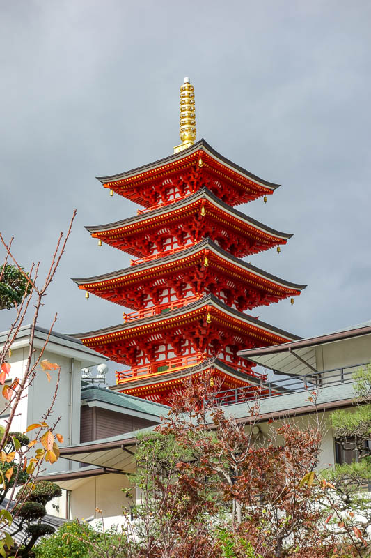 Japan 2015 - Tokyo - Nagoya - Hiroshima - Shimonoseki - Fukuoka - There were shrines everywhere here, but this one takes the cake. Its bright red, I tried to get to the base of it, it emerges from the roof of a facto