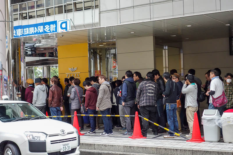 Japan 2015 - Tokyo - Nagoya - Hiroshima - Shimonoseki - Fukuoka - The allure of the sole object in this world has people lined up waiting for opening time all over Japan. Dont these guys have jobs? Its only men. If t