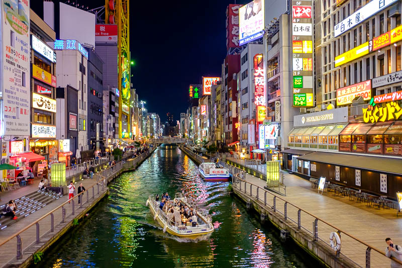 Japan-Osaka-Shinsaibashi-Glico Man-Curry - People on a boat enjoying the view.