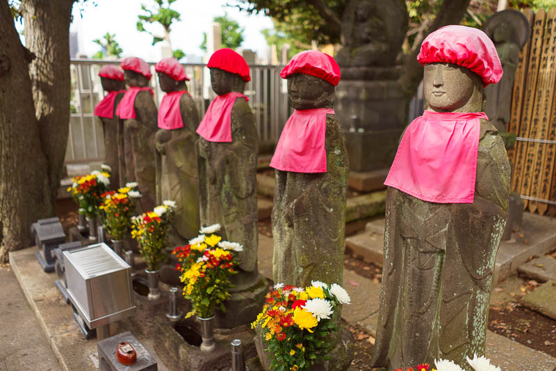 Japan-Tokyo-Ueno-Nakano - They also have these cool series of Buddhas or whatever wearing their red jockey caps. Entire mountains have been vandalised with these things.