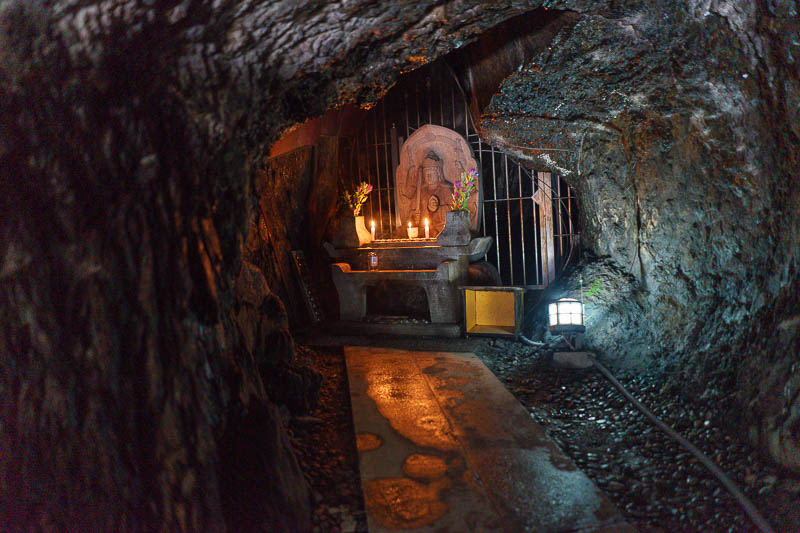 Japan-Tokyo-Hiking-Takao-Mount Jinba - I dont think I was supposed to be in this area, but I found a cave you cant stand up in with various candles and stuff at the end.