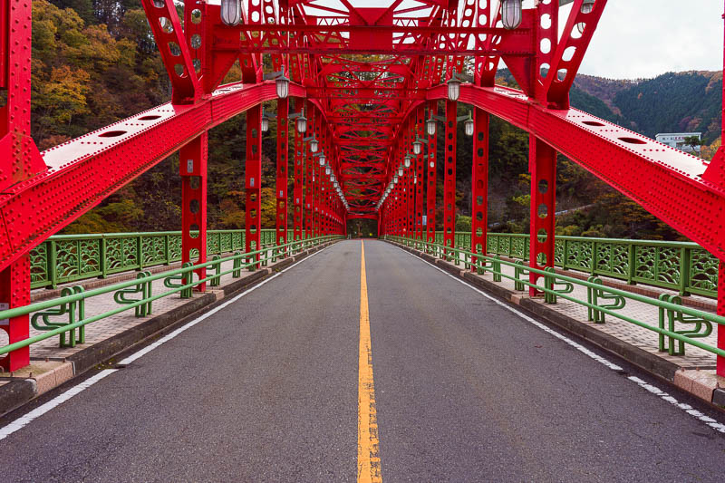 Japan-Okutama-Lake-Hiking - A red bridge is an opportunity for me to stand in the road again and hope the traffic behind me isnt a silent electric car I dont hear coming.
