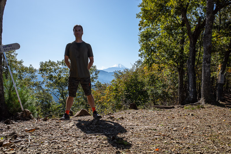 Japan for the 9th time - Oct and Nov 2019 - Its me, at summit #2 for the day, Mount Kuratake, with another mountain in the distance behind me. Those are my awesome new orange technology socks. T