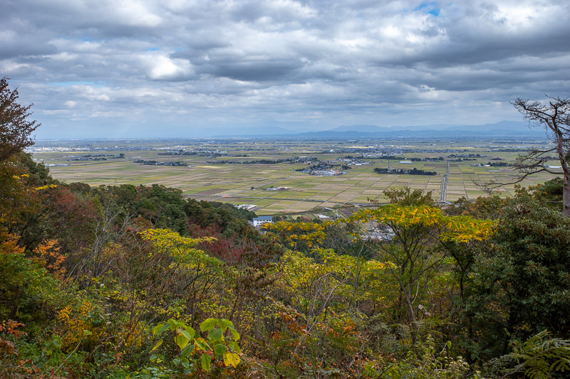 Japan-Niigata-Hiking-Mount Yahiko - I passed a number of mini shrines and graves on my way down. Heres a low down view looking back towards Niigata. A good spot to urinate I decided.