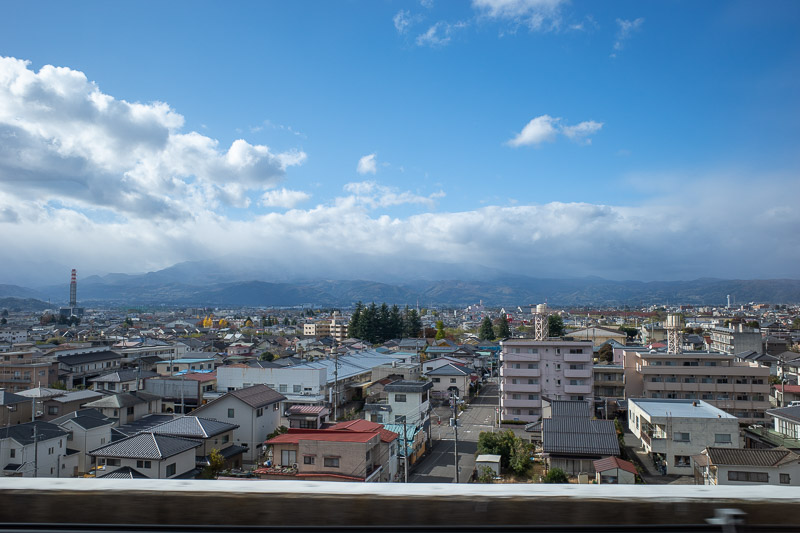 Japan-Yamagata-Koriyama-Shinkansen - Here is the view just out of Fukushima station, towards the mountains I would like to climb tomorrow. They are in cloud right now. Actually as I type 