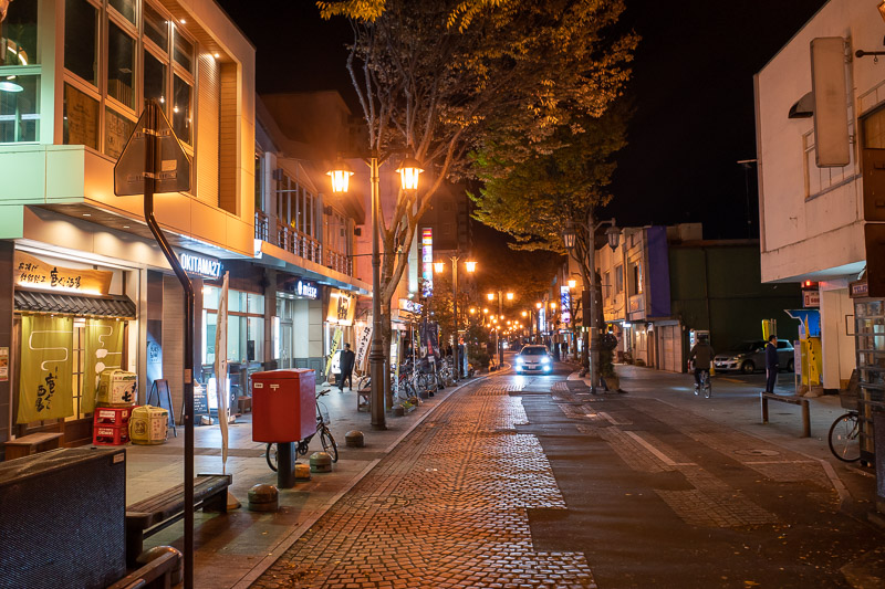 Japan for the 9th time - Oct and Nov 2019 - This looks like the boutique shopping street. Very orange lighting. Very dug up brick paving.