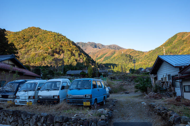 Japan for the 9th time - Oct and Nov 2019 - Back at the road! These minivans sit in front of the mountains I had just descended from in the late afternoon sun.