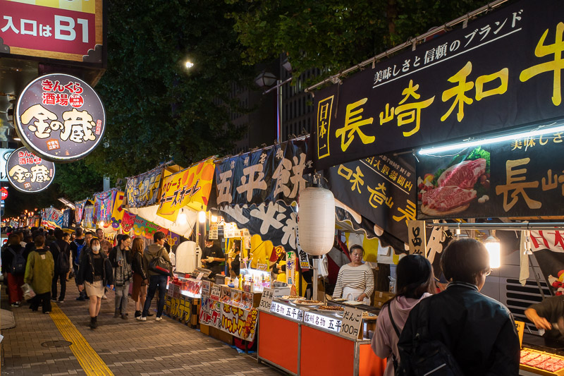 Japan for the 9th time - Oct and Nov 2019 - Right by my hotel, food stalls have set up in the street. Mainly serving octopus balls and twisted potato on a stick. The idea of standing and eating 