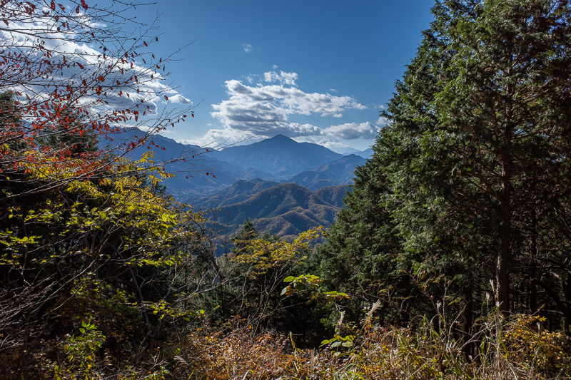 Japan for the 9th time - Oct and Nov 2019 - If you look to the right of the green peak in the middle, you can see the white peak of Fuji in the cloud in the distance. I have climbed some of thos