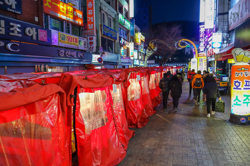 Korea-Busan-Neon-Beef-Department Store - In each of these red tents is a different pop up restaurant, selling things on sticks mainly.