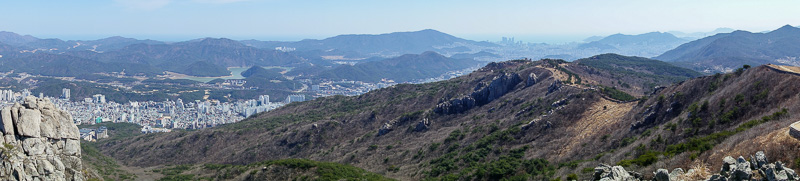 Korea-Busan-Hiking-Geumjung - 2nd panorama for today, featuring rocks, wall, city and ridge.