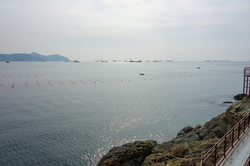Korea-Busan-Beach-Songdo - Ocean boardwalk affords a great view of the local oyster farms. Their delicate flavour is accentuated by the shipping frequenting the worlds second bu