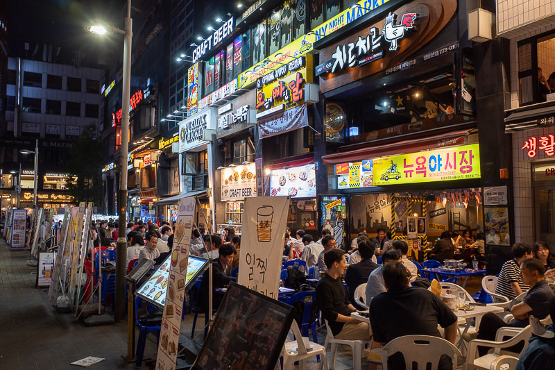 Korea-Seoul-Myeongdong - There are still some busy areas full of people eating. Mainly mystery sea creatures. Officially you do not need to wear a mask outside anymore, as of 