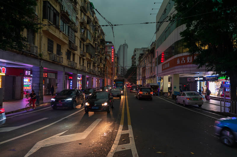 China-Guangzhou-Rain - Car lights lighting up the road at 11am.