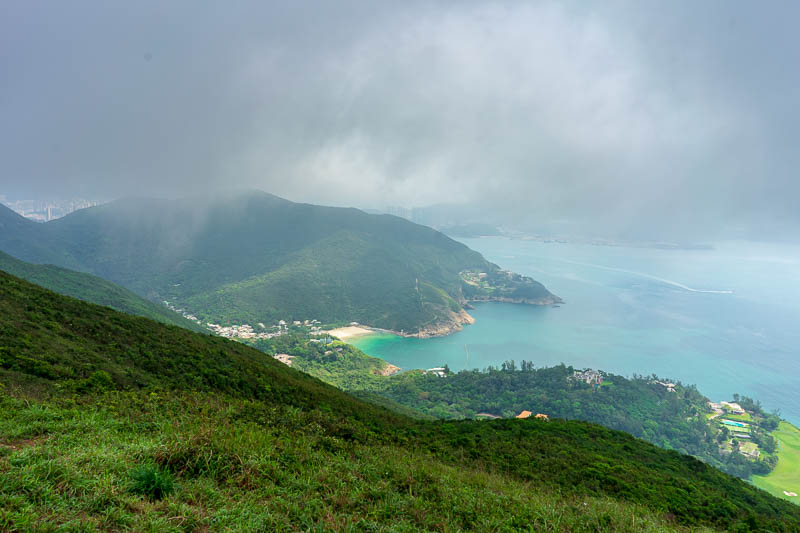 Hong Kong-Hiking-Dragons back - My course would follow the ridge just to the left of this shot, in the fog. You can see golf courses below. They like to hide them in Hong Kong in are