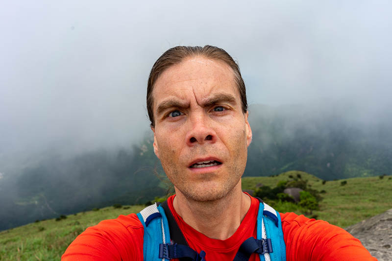 Korea - HK - China - KORKONG! - Last of my big head up-nostril shots. Today I wore my actual running clothes, bright orange shirt, shorts with zip up pockets. This was a wise choice.