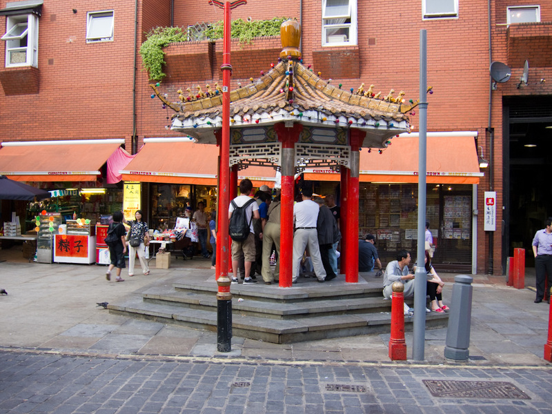 England-London-China Town-Pho - I dont know whats happening here, but these guys crowded into the pagoda are very excited about it.