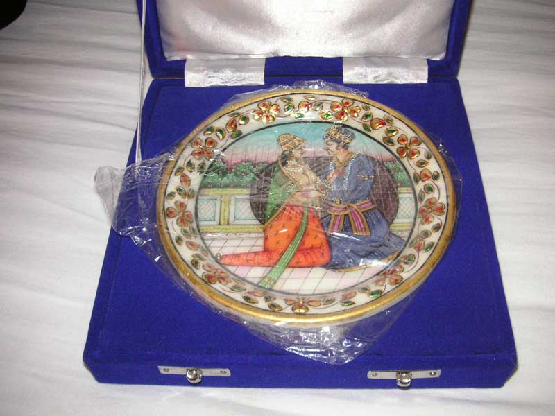 India-Chennai - A plate of traditional Indian design presented in a fancy box, with a stand, the edges and decorations appear to be gold leaf, I have left it wrapped 
