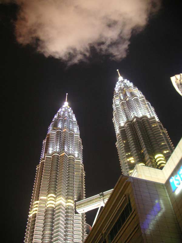 Malaysia-Kuala Lumpur-Petronas Towers - Looking up at the towers, camera laying almost on its back, using its strap as a wedge.