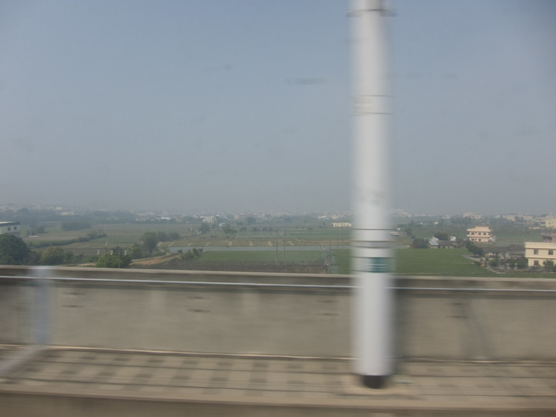 Taiwan-Taipei-Kaohsiung-Bullet Train - Out of my window I was looking towards the coast, big stretches were amazingly flat like this, full of farmlands. As soon as you were in a region not 
