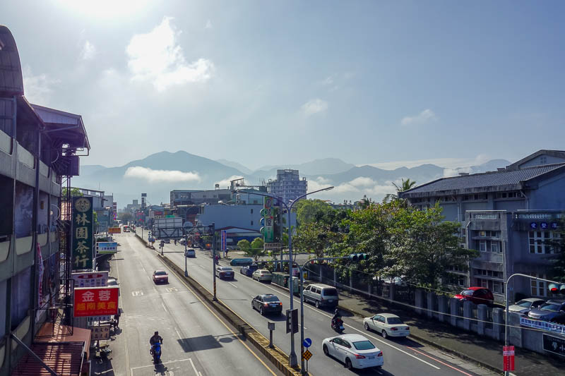 A full lap of Taiwan in March 2017 - A well placed elementary school overpass gave me an opportunity to take a photo of the town and the mountains. Parents crossing with their children we