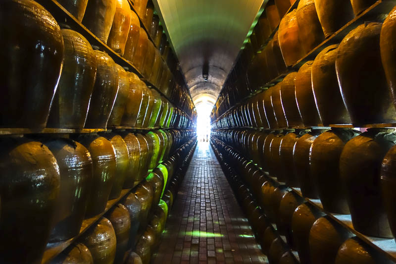 Taiwan-Puli-Taipei-Bullet Train - On the museum gift shop tour, you can walk through a cave of liquor vats. There is not a lot of room and they seem to just be resting on planks!