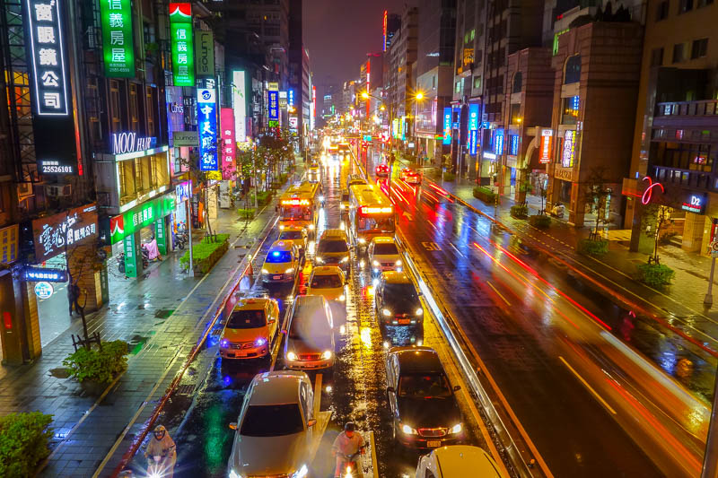 Taiwan-Taipei-Rain-Food-Vegetarian - And heres some proof that I am a lunatic. I climbed up onto the overpass to take a photo of traffic in the rain. Nice reflections. The people below as