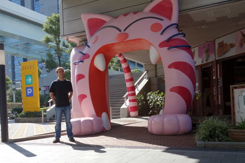 Japan-Tokyo-Odaiba-Gundam - Here I am, in Japan, standing in front of a cat cafe, which is guarded by a giant pink cat. This area, called Odaiba which is an island of reclaimed t